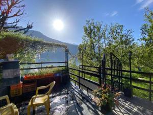 a balcony with a fence and a view of the water at Nature Nest in Manāli