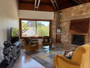 a living room with couches and a stone fireplace at L'Olivada, villa d'exception in Ganges