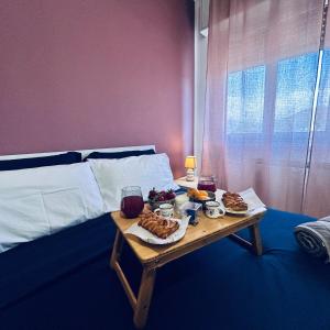a table with food on it next to a bed at Panoramic Terrace & Sea View Flat with Free Parking in Genoa +95 photos