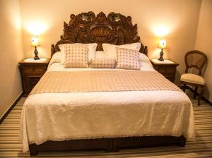 
a bedroom with a bed and a night stand at Casa Aliz in San Miguel de Allende
