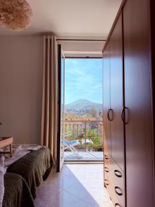 a bedroom with a bed and a door to a balcony at Hotel Momora in Bardineto +63 photos
