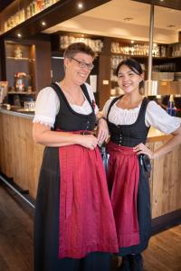 two women are standing in front of a bar at Hotel-Restaurant Dechbettener Hof in Regensburg