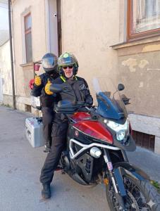 a man is sitting on a red motorcycle at Studio apartman Ela in Travnik
