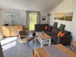 a living room with a couch and a table at Seeschwalbe 240 in Mirow
