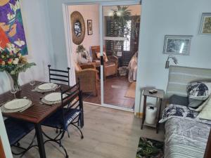 a living room with a table and a couch at Twelveon1st in Cape Town