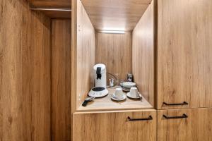 a wooden cabinet with a coffee maker in it at Schinagl Klaus in Klaus an der Pyhrnbahn