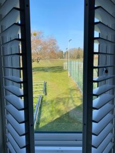 a window view of a field from a house at Guest house in Compton in Winchester