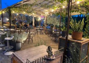 a patio with tables and chairs under a pergola at Gite de La Cueille - Chambre double in Ribes