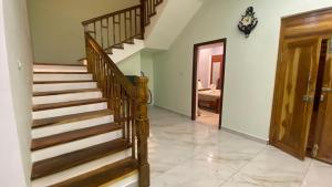 aoyer with a wooden staircase in a house at Bay Breeze Vijay Villa in Pondicherry