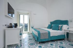 a white bedroom with a bed and a window at Guesthouse with Suites on the Amalfi Coast - Residence Villa Ruocco near Amalfi - 300sqm Open Terrace near Ravello - Breathtaking View in Scala