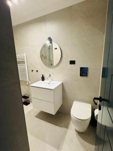 a bathroom with a toilet and a sink and a mirror at APARTAMENT MAYA - Julia Vieste in Vieste +13 photos