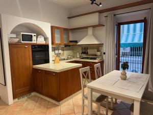 a kitchen with wooden cabinets and a table with a white counter top at APARTAMENT MAYA - Julia Vieste in Vieste