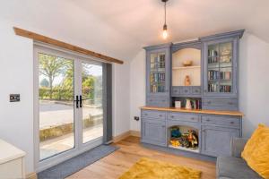 a home office with a blue cabinet and a window at The Shed in Coventry