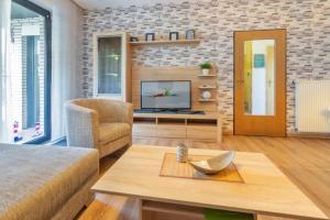 a living room with a couch and a television at Matjesliebe in Dornumersiel