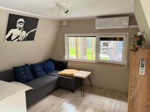 a small living room with a couch and a table at Domek Kitara in Skorochow