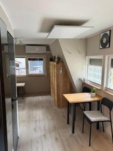 a room with a table and chairs and a staircase at Domek Kitara in Skorochow