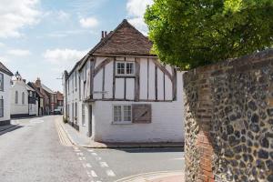 an old white building on the side of a street at Crafters Cottage in Sandwich