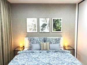 a bedroom with a bed with three pictures on the wall at Apartmán Klement in Znojmo