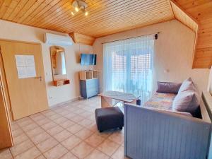 a living room with a couch and a table at Apartment Anikó Nr 7 in Vonyarcvashegy