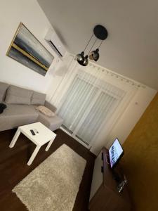a living room with a couch and a table at Apartman S in Vrnjačka Banja