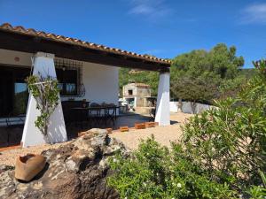 a view of a house with a patio at Villa Altora in Nuragheddu