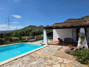 a villa with a swimming pool and a house at Villa Altora in Nuragheddu