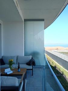 a living room with a couch and a table at Szemesbay Serenity Apartman in Balatonszemes