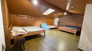 a room with a bed and a couch and a chair at Ubytování u Šimků in Broumov