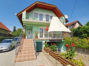 a house with a car parked in front of it at Apartment Anikó Nr 7 in Vonyarcvashegy