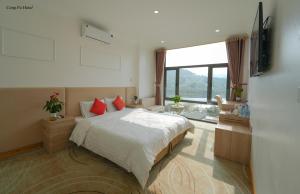 a bedroom with a bed and a large window at Cong Fu Hotel in Bắc Hà +53 photos