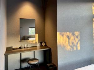 a vanity with a mirror and a chair in a room at Hope Private Villa tateyama in Tateyama