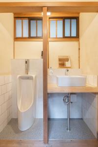 a bathroom with a urinal and a sink at 宿坊 大泰寺 Temple Hotel Daitai-ji in Nachikatsuura +68 photos