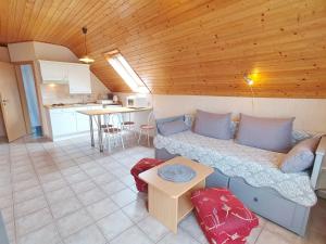 a living room with a couch and a kitchen at Apartment Anikó Nr 7 in Vonyarcvashegy