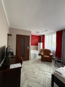 a living room with a couch and a desk in a room at AtmosferA in Bydgoszcz
