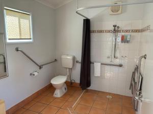 a bathroom with a toilet and a shower at Longreach Starlight Cabins - Boutique Outback Accommodation in Longreach