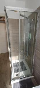 a shower with a glass door in a bathroom at PINK & GREEN APARTMENTS - RHO FIERA MILANO MIND - Andrea in Rho +114 photos