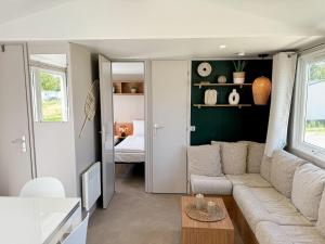 a living room with a couch and a table at Chalet Duin & Zee 44, Renesse in Renesse