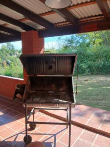 a barbecue grill sitting on top of a patio at Miralrio in Santa Rosa de Calamuchita