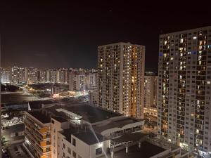 a city skyline at night with tall buildings at Home Transit Hulhumale' Phase 2 in Male City