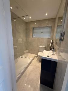 a bathroom with a shower and a sink and a toilet at Windsor side in Datchet