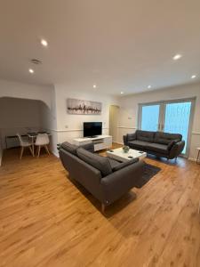 a living room with two couches and a table at Windsor side in Datchet