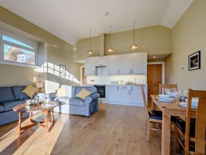 a living room with a blue couch and a table at 2 Bed in Hawick oc-86021 in Hawick