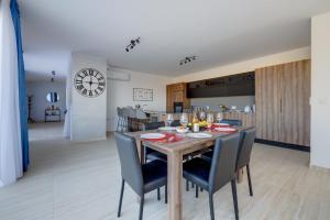 a dining room and kitchen with a table and chairs at Superlative 3BR Penthouse, Private Pool and Views in Hal Ghaxiak