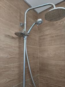 a shower head in a bathroom with a wooden floor at A Estrenar Estudio las Cañitas in Buenos Aires +17 photos