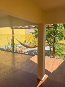 a room with a hammock and a view of a lake at Morada 1000 - Pousada in Frutal