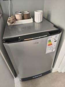 a refrigerator with a shelf on top of it at A Estrenar Estudio las Cañitas in Buenos Aires