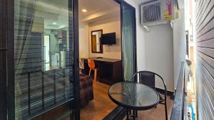 a small room with a table and a desk at Smyrna in Pattaya