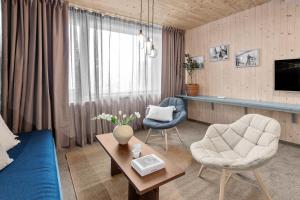 a living room with a couch and two chairs at RS Noatun in Horten