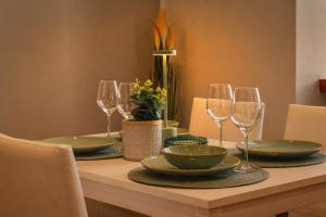 a dining room table with plates and wine glasses at Marconi Home in Trieste