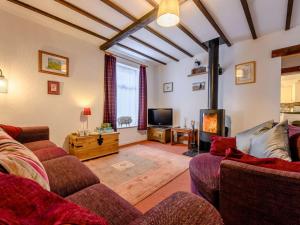 a living room with two couches and a tv at 1 Bed in Penrith oc-90417 in Kirkoswald
